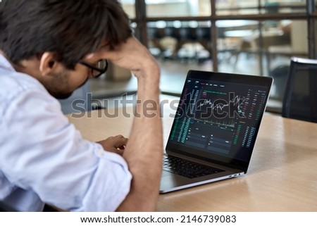 Stressed business man crypto trader broker investor analyzing stock exchange market crypto trading decreasing chart data fall down loss, desperate about losing money of crisis, recession, inflation.