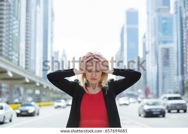 Stressed business woman\
in the busy city. 