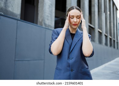 Stressed business woman having headache from overworked