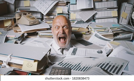 Stressed Businessman Buried Under A Lot Of Paperwork, He Is Angry And Screaming