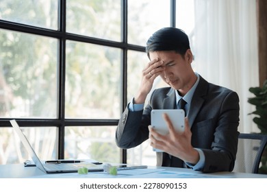 Stressed businessman calculating bills and taxes looking at calculator gesturing with hands sitting at work desk. - Shutterstock ID 2278090153