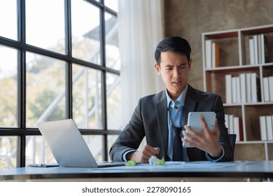 Stressed businessman calculating bills and taxes looking at calculator gesturing with hands sitting at work desk. - Shutterstock ID 2278090165