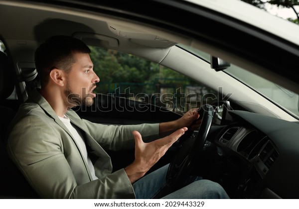 Stressed
businessman in driver's seat of modern
car