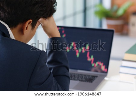 Stressed businessman feeling desperate on crisis stock market, investment concept.