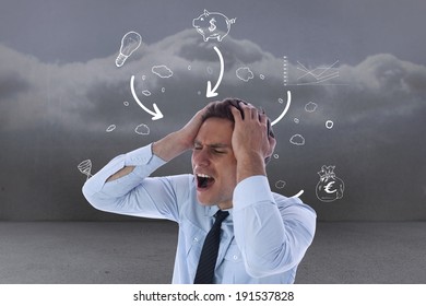 Stressed businessman with hands on head against clouds in a room