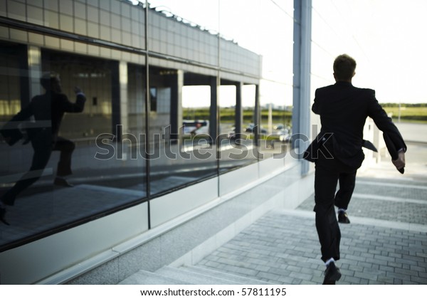 stressed businessman running\
away