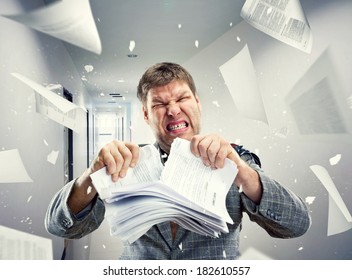 Stressed Businessman Tearing Out Stack