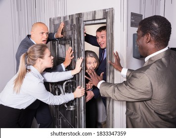 Stressed Businesspeople Closing Door In Quest Room Stylized Under Bunker So That Other People Do Not Enter. 