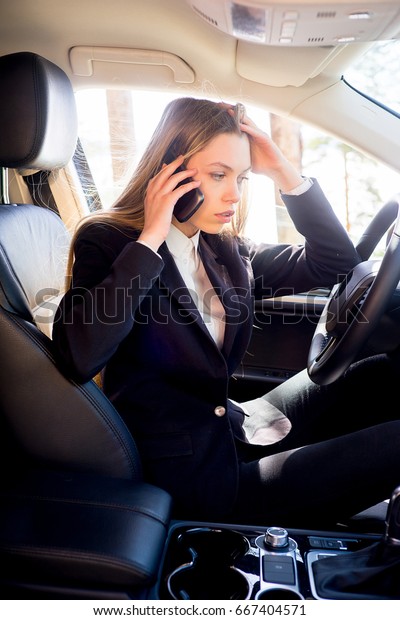 Stressed businesswoman in a\
car