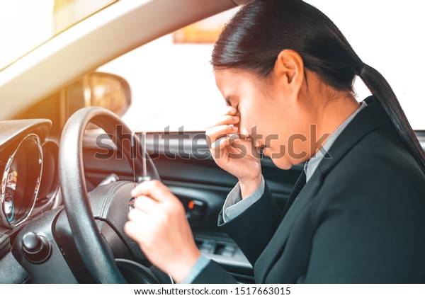 Stressed businesswoman feeling headache in car,\
feeling anxiety