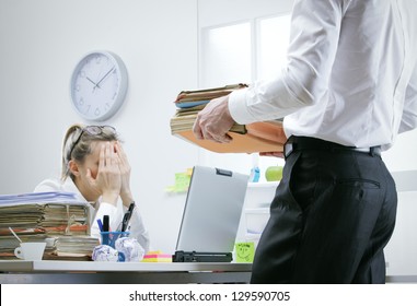 Stressed businesswoman with a too much paperwork and documents