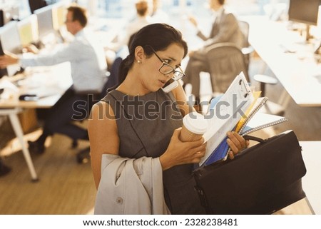 Stressed businesswoman struggling to multitask in office