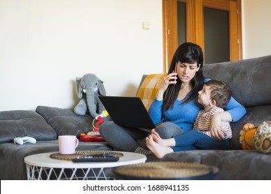 Stressed busy woman on business call working on laptop at home with her child. Single mother telecommuting. Telework and family concept.