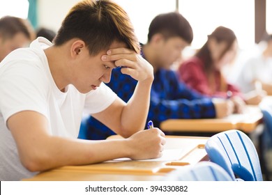 Stressed College Student  For Exam In Classroom