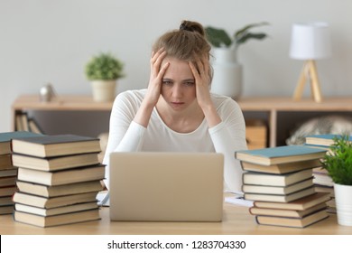 Stressed college student tired of hard learning with books and laptop in exams tests preparation, overwhelmed high school teen girl exhausted with difficult studies or too much homework, cram concept