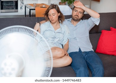 Stressed couple trying to refresh from summer heatwave