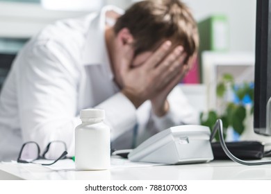 Stressed Doctor Cover Face Under Pressure. Sad Nurse, Tired Physician Or Upset Doc. Medic Crying In Hospital Office. Malpractice, Treatment Error And Mistake Or Negligence. Workplace Bullying.