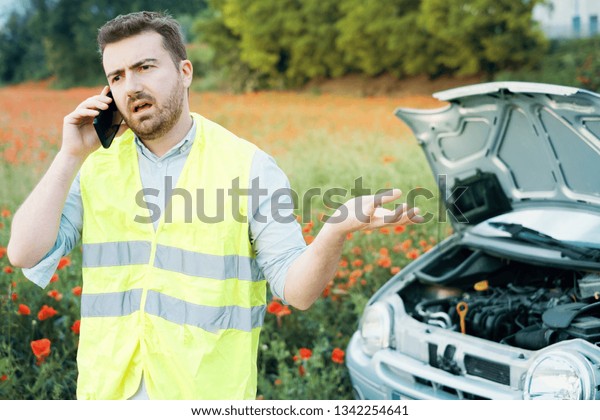 Stressed driver after car breakdown calling\
roadside service