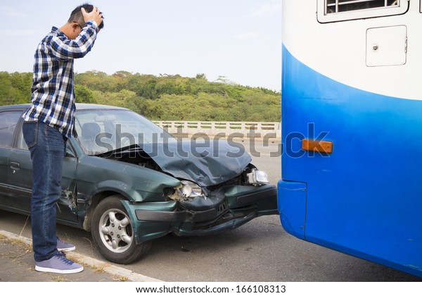 Stressed Driver looking at car After Traffic\
Accident on the road