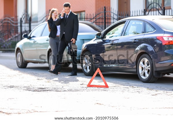 Stressed drivers\
near broken cars after\
accident
