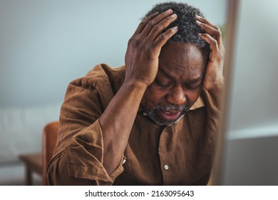 Stressed elderly grey-haired man in glasses look at laptop screen have problems paying bills taxes online. Thoughtful mature 70s male manage household finances, calculate expenses expenditures at home - Powered by Shutterstock