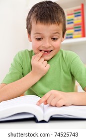 Stressed Elementary School Boy With Reading Problems Trying To Remember