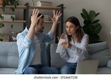 Stressed emotional couple arguing fighting when checking financial papers together finding unexpected debt lack of money on bank account. Mad angry husband scolding wife for overspending family budget - Powered by Shutterstock