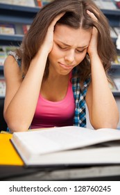 Stressed Female Student In A University Library