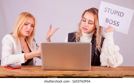 Stressed Female Worker Holding Sign Stupid Boss. Conflict Concept. Horizontal Image.