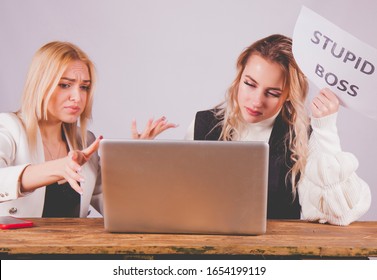 Stressed Female Worker Holding Sign Stupid Boss. Conflict Concept.