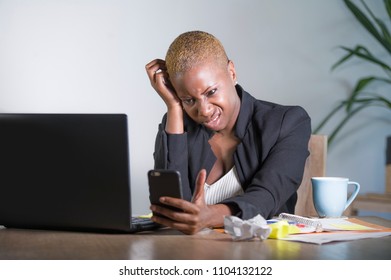 Stressed And Frustrated Afro American Black Woman Working Upset At Office Laptop Computer Desk Gesturing Angry Looking At Mobile Phone Stressed And Tired In Business And Work Problem 