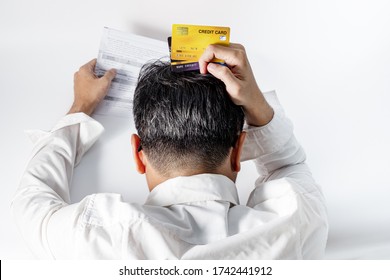 Stressed Gray Haired Man Wear White Wrinkled Shirt Holding Credit Card And Scratch The Head Worried Debt, Bills Bank Statement,feeling Desperate In Bad Financial Situation And Bankruptcy