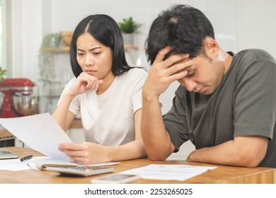 Stressed, hand of asian young couple love family, confused by calculate expense from invoice or bill, have no money to pay. Mortgage, loan causing debt, bankruptcy. Debt problems, Financial people. - Shutterstock ID 2253265025