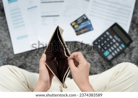 Stressed and headache woman with large bills or invoices no money to pay to expenses and credit card debt. shortage, Financial problem, bankruptcy, mortgage, loan, bankrupt, poor, empty wallet 