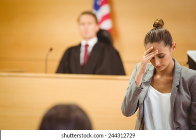 Stressed Lawyer With Head Bowed In The Court Room