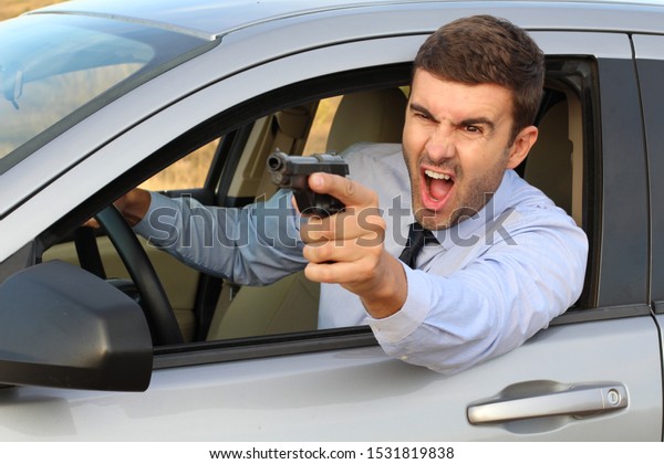 Stressed male\
driver yelling and holding a\
gun
