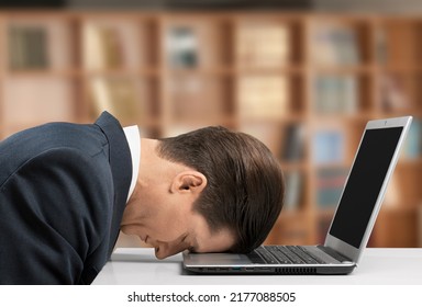 Stressed Male University Or College Student With Poor Mental Health Studying With Laptop In Room