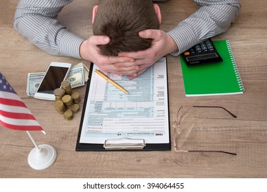 Stressed Man Filling 1040 Tax Form