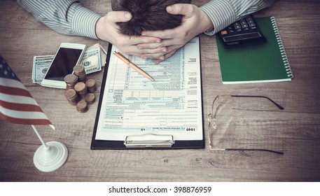 Stressed Man Filling 1040 Tax Form. Toned Image