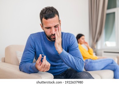 Stressed Man Holding Her Wedding Ring Worried About Breakup Or Divorce, Avoid Talking With Wife After Fight, Anxious Couple Ignore Each Other. Frustrated Sad Husband Taking Off The Wedding Ring