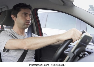 Stressed man huffing and puffing while driving. Reckless driver losing patience in traffic jam