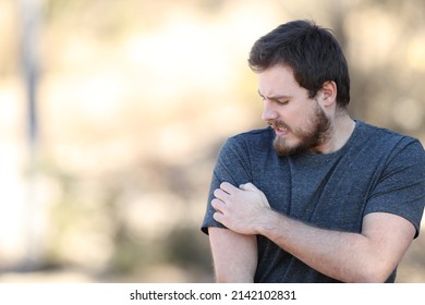 Stressed Man Scratching Itchy Arm Complaining In Nature