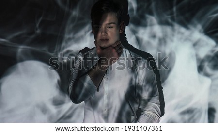 Stressed man. Trapped frustrated. Panic attack. Mental disorder. Fear paranoia. Scared guy holding hand on neck in tense blur miracle dark shadow lights reflection on background double exposure.