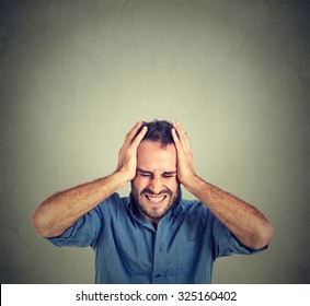 stressed man upset frustrated isolated on gray wall background. Negative human emotions 