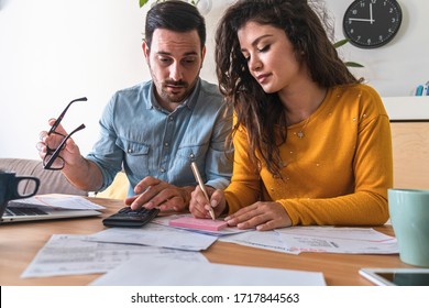 Stressed Man And Woman Talking About Family Budget,  Calculating Household Bills And Expenses At Desk Stock Photo