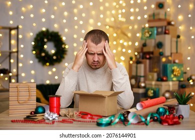 Stressed man wrapping christmas present at home - Powered by Shutterstock