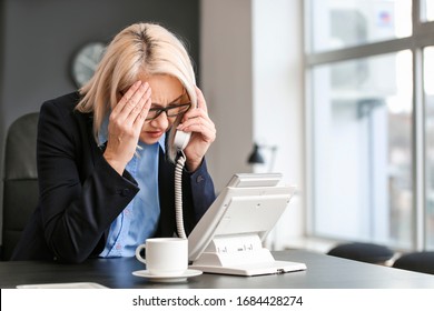 Stressed Mature Woman Being Informed About Her Dismissal By Phone