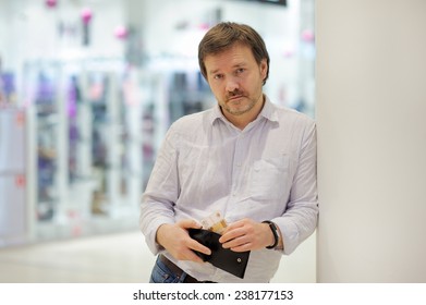 Stressed Middle Age Man Holding Purse With Russian Paper Money (rubles) At Shopping Mall