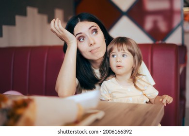 Stressed Mom Sitting With Her Child In A Restaurant Booth. Unhappy Tired Mother Worried About Picky Eating Habits Of The Child

