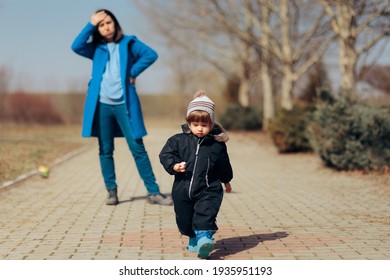 Stressed Mother Supervising Child Playing Outdoors. Overprotective Mom Watching Over Child Playing Outdoors
